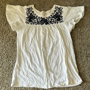 White blouse with blue floral embroidered pattern